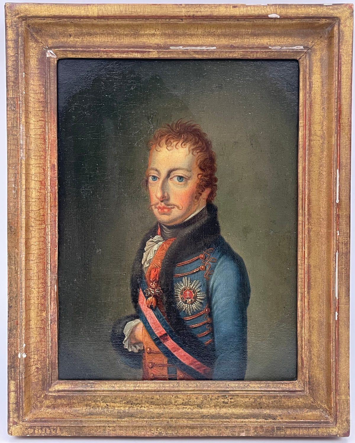Portrait of a hussar officer in pale blue dolman with black fur pelisse and a silver breast star, early 19th century Austrian oil on canvas in a period gilt frame