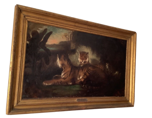 Two tigers resting before a dark rock at dusk, mid 19th century French oil on canvas in a gilt frame