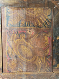 Detail of the painted reverse showing yellow and red scrollwork cut off at the panel edge