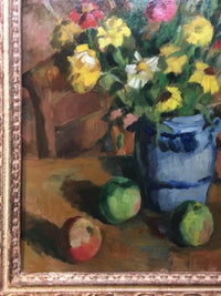 Lower left detail showing the two green apples and the red one against the ochre table, the blue jug built in flat strokes, with the frame fillet at the edge