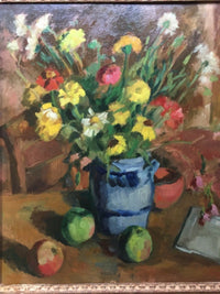 The whole arrangement seen close, yellow and white flowers massed above the blue and grey jug with two green apples, a red one and a terracotta bowl