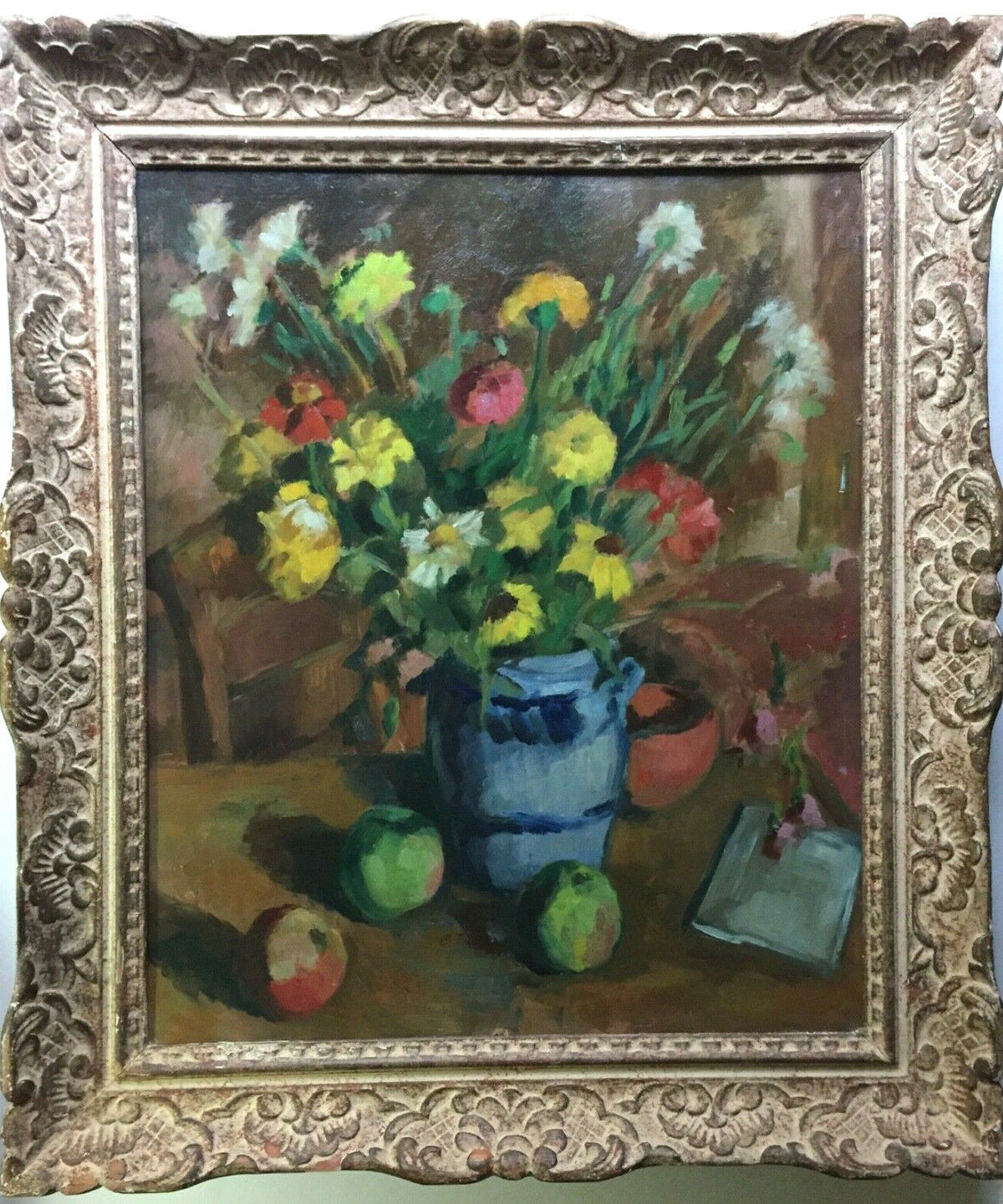 Wildflowers in a blue and grey stoneware jug with green and red apples on a table, signed oil by Andre Charigny in a carved cream and red bole frame