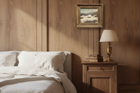 Signed winter snow landscape by Alfred Andrieux in a gilt frame in a wood-paneled bedroom