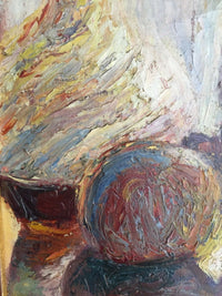 Close view of the round fruit turned in a single spiral of red, blue and ochre beside the loaded flank of the carafe