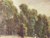Macro of the treeline with the white walls of a hamlet showing between the trunks