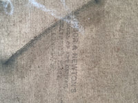 Faded colourman's stamp printed vertically on the raw canvas
