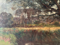 Macro of the far bank with a single figure standing in the cut field beyond the reeds