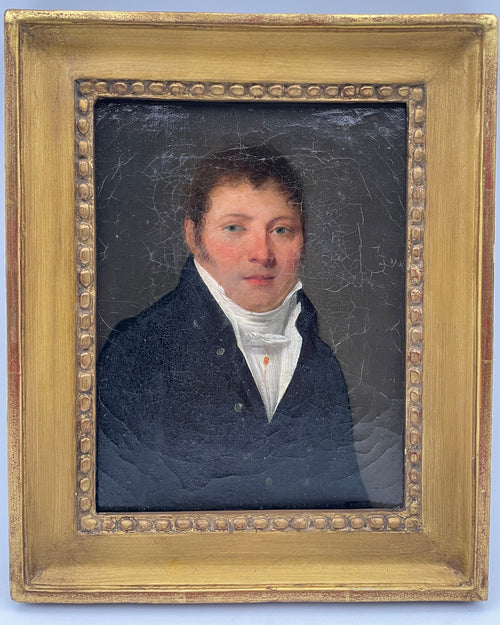 Young man in a dark coat and high white cravat against a grey ground, small early nineteenth century French oil portrait in its original gilt bead frame