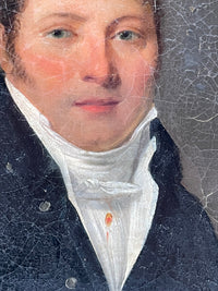 The sitter's face and high white stock seen close, with the red rosette and its ribbon tail at the buttonhole, and craquelure across the coat and ground