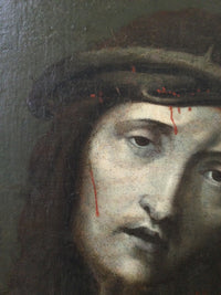 Macro of the crown of thorns in the Ecce Homo showing the plaited branches, the thorn tips at the temple and the blood running down the cheek over the age craquelure