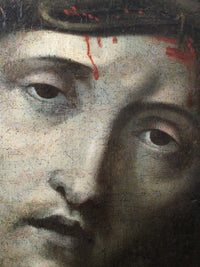 Macro of the eyes in the Ecce Homo showing the fine age craquelure through the flesh and the bright red of the blood sitting uncracked on the surface