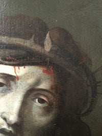Macro of the right temple in the Ecce Homo showing the plaited crown, a pale leaf caught in the branches and the thorn tips drawn out against the olive ground