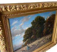Corner of the carved gilt frame showing the acanthus and berry frieze and the beaded courses, the gold rubbed through to the red bole on every crest