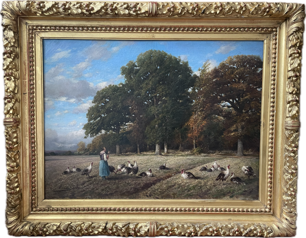 A girl in a blue skirt feeding a flock of turkeys in a shorn field at the edge of an oak wood, signed oil by Emile Michel dated 1872, in a carved gilt frame