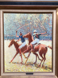 Close view of the two riders, one in blue and one in dark green, their mallets swung high above the chestnut ponies at the gallop