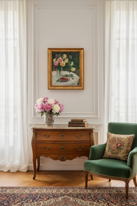 The François-Aubert still life hanging above a walnut commode in a light Parisian room, showing the scale of the framed canvas
