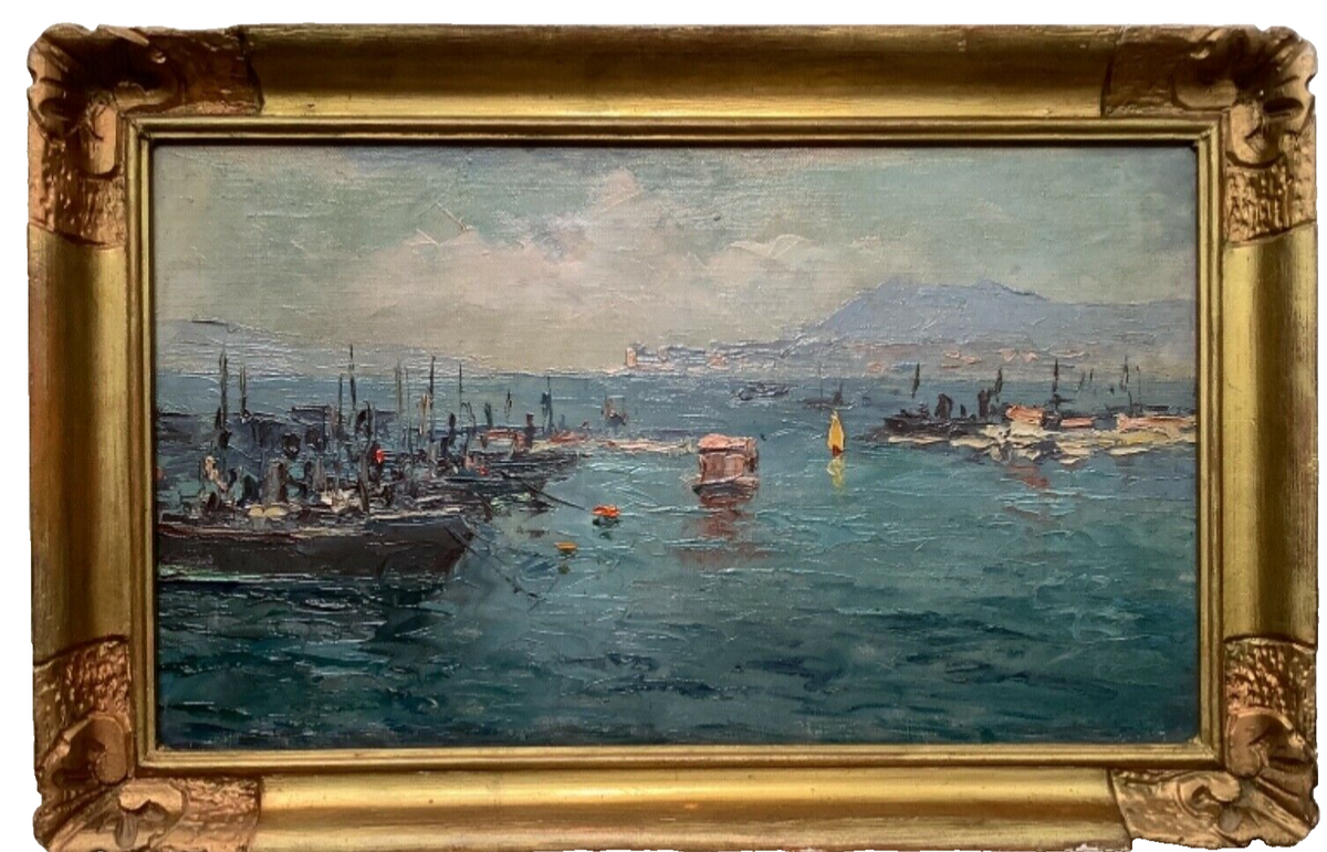 French oil on canvas of fishing boats moored in a harbour, in a gilt frame with carved corner ornaments