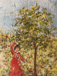 Reaching up into the young fruit tree, the girl in red above her almost full basket