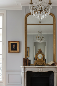 The small gilt framed portrait hung on a pale panelled wall beside a marble fireplace (17th century German portrait)