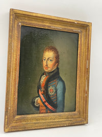 Angled view of the framed portrait showing the shallow gilt moulding and the crazed water gilding across the flat