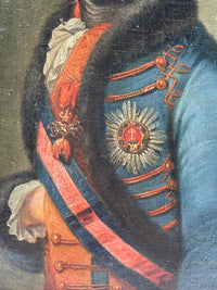 Macro of the chest showing the breast star, the jewelled badge on its neck ribbon and the broad sash crossing the gold laced red waistcoat