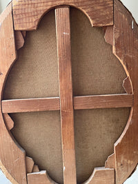 Close view of the oval stretcher built from angled wooden segments jointed edge to edge, with a halved cross brace and plane marks across the timber
