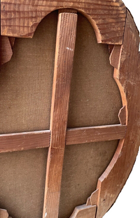 Three quarter view of the oval stretcher showing the segments stepped along their inner edge to follow the curve, with the halved cross brace set back in the depth