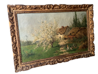 Side view of the framed canvas with the artist signature visible at the lower left