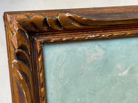 Macro of the hand carved giltwood frame with its water leaf ornament, the gilding worn to an ochre red ground and small losses scattered along the mouldings