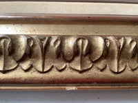 Detail of the carved leaf and tongue moulding of the gilt frame