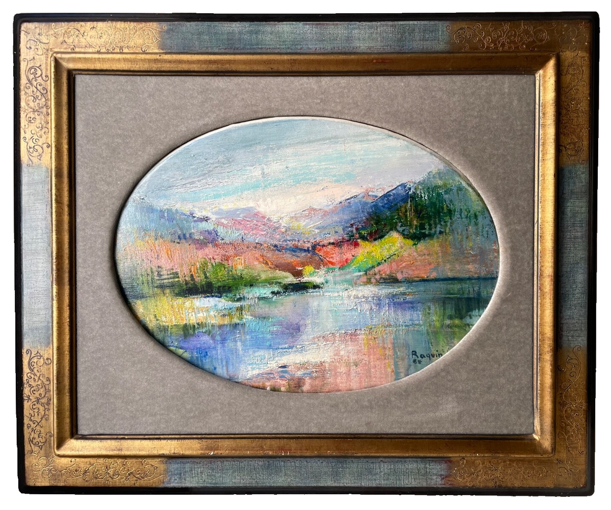 An oval lake landscape titled Lake District, signed oil on canvas by Iris Raquin, 1964, in a gilt frame with a grey linen mount