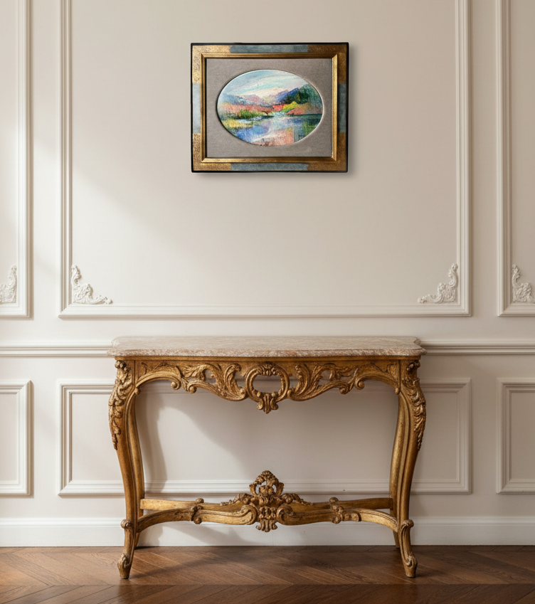 Signed oval lake landscape by Raquin in a gilt frame above a Louis XV console in an elegant French interior