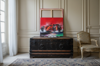 The canvas shown to scale above a low sideboard in a light room (Victor Spahn Formula One painting, oil on canvas)