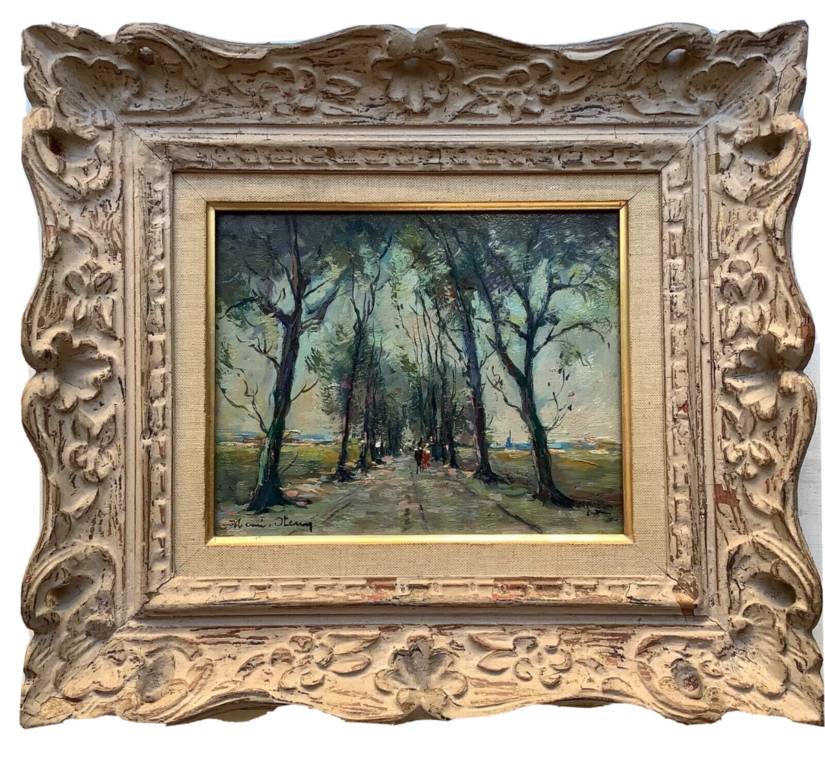 An avenue of trees with figures on the path, signed Henri Stenn, in a carved and whitewashed frame