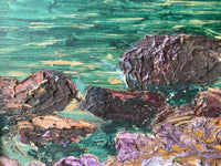 Turquoise dragged flat and horizontal, the boulders in front of it left unblended