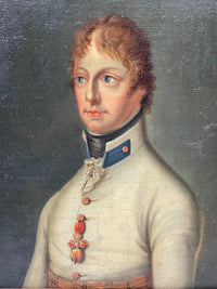 Head and shoulders above the white coat, a single red ribbon on the chest