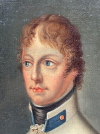 Red curls cut short over the forehead, blue eyes turned to the left